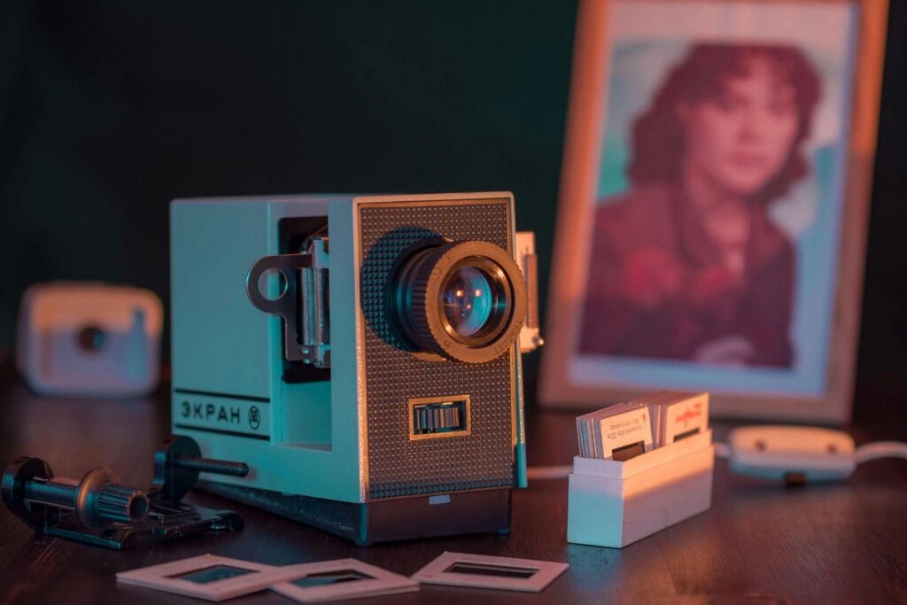 A vintage camera placed on a wooden desk