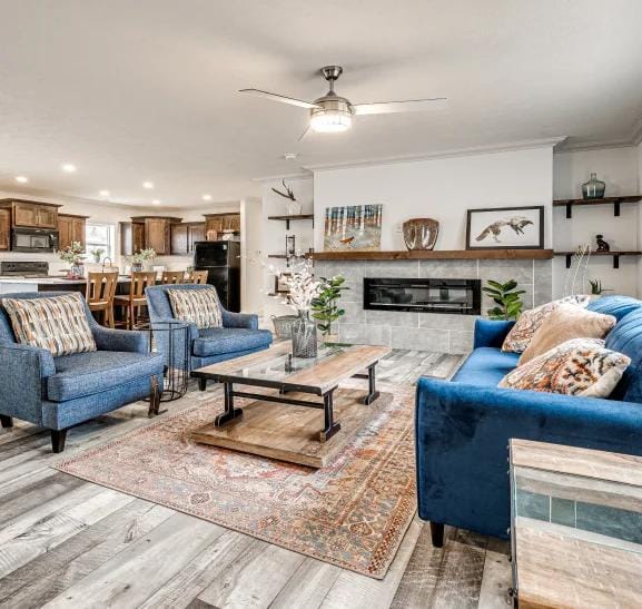 blue sofas in a full furnitured lounge area connected to the kitchen with a center table