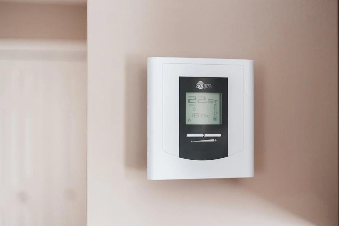 close-up of a white and place thermostat placed on a wall